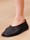 Runway side image of the Square Perforated Slippers in black
