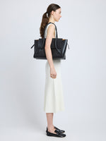 Image of model carrying Tate Bag in Smooth Calfskin in BLACK