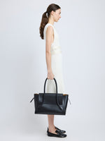 Image of model carrying Tate Bag in Smooth Calfskin in BLACK