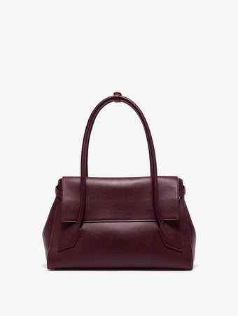 Front image of Tate Bag in Smooth Calfskin in dark red with sides tucked