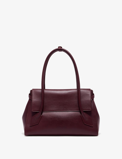 Front image of Tate Bag in Smooth Calfskin in dark red with sides tucked