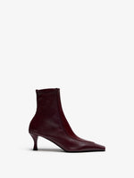 Proenza Schouler Still Life Image of Front View of Trap Stretch Ankle Boot 60MM Lizard Combo in Oxblood