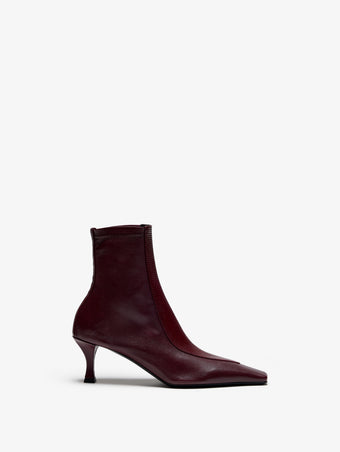 Proenza Schouler Still Life Image of Front View of Trap Stretch Ankle Boot 60MM Lizard Combo in Oxblood