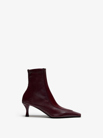Proenza Schouler Still Life Image of Front View of Trap Stretch Ankle Boot 60MM Lizard Combo in Oxblood