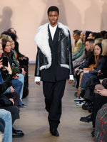 Runway image of model wearing Wool Stretch Suiting Trousers in BLACK