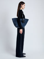 Image of model carrying Large Bedford Tote in Suede in navy/black