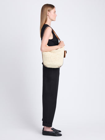 Image of model wearing Raffia Spring Bucket Bag in IVORY