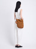 Image of model wearing Raffia Spring Bucket Bag in HONEY