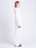 Side full length image of model wearing Nina Coat In Solid Cotton Crinkle in OFF WHITE