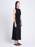 Side full length image of model wearing Beatrice Dress In Solid Jersey in BLACK