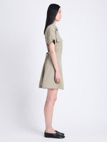 Side full length image of model wearing Carmine Dress In Solid Cotton Crinkle in BAYLEAF