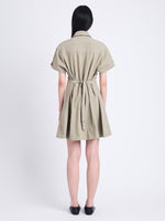 Back full length image of model wearing Carmine Dress In Solid Cotton Crinkle in BAYLEAF
