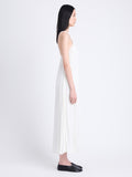 Side full length image of model wearing Celeste Dress In Lightweight Crepe in OFF WHITE
