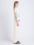 Side image of model wearing Finley Tie Dye T-Shirt in white/navy/olive