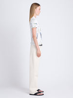 Side image of model wearing Finley Tie Dye T-Shirt in white/navy/olive