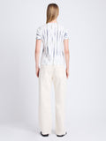 Back image of model wearing Finley Tie Dye T-Shirt in white/navy/olive