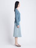 Side full length image of model wearing Iris Wrap Skirt In Stretch Twill in GREY INDIGO