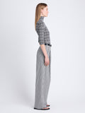 Side full length image of model wearing Amber Pant In Solid Cotton Crinkle in BLACK/IVORY