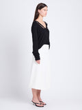 Side full length image of model wearing Elsie Top In Midweight Button Details Knits in BLACK