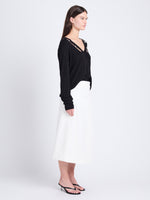 Side full length image of model wearing Elsie Top In Midweight Button Details Knits in BLACK