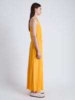Side full length image of model wearing Lenny Dress in Matte Jersey in MARIGOLD