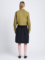 Back full length image of model wearing Alma Shirt in Peached Poplin in OLIVE