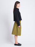 Side image of model wearing Olive Skirt in Peached Poplin in OLIVE