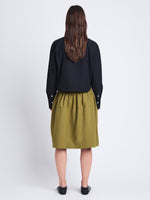 Back image of model wearing Olive Skirt in Peached Poplin in OLIVE