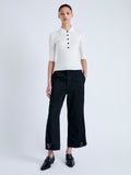 Front full length image of model wearing Cooper Knit Polo in Micro Cable in OFF WHITE