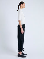 Side full length image of model wearing Cooper Knit Polo in Micro Cable in OFF WHITE