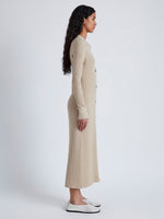 Side image of model wearing Phillips Knit Dress in Micro Cable in CASHEW