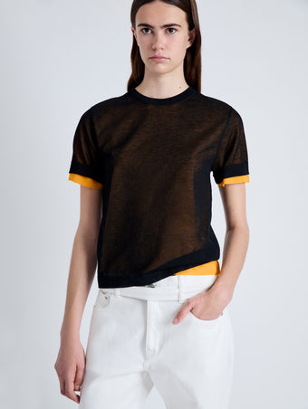 Detail image of model wearing Powell Sheer Knit Top in BLACK/MARIGOLD