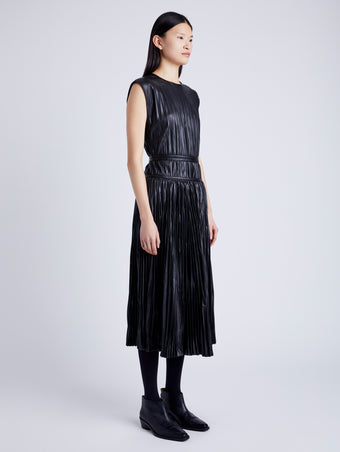 Proenza Schouler Side full length image of model wearing Lyra Pleated Top in Lightweight Faux Leather in BLACK
