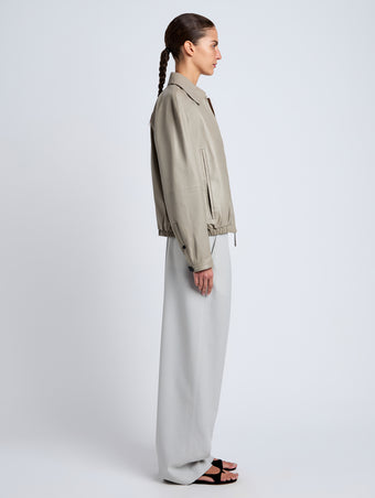 Proenza Schouler Side full length image of model wearing Beck Bomber in Lightweight Nappa in Granite