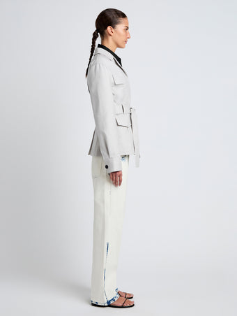 Proenza Schouler Side full length image of model wearing Indie Jacket in Stretch Cotton Suiting in Pale Grey