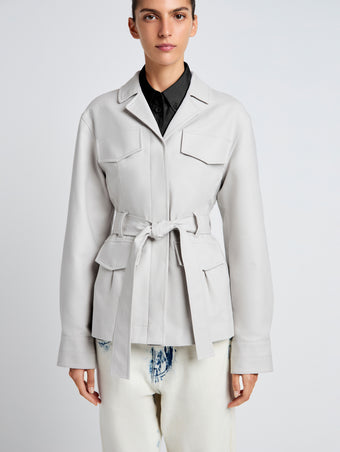 Proenza Schouler Detail image of model wearing Indie Jacket in Stretch Cotton Suiting in Pale Grey