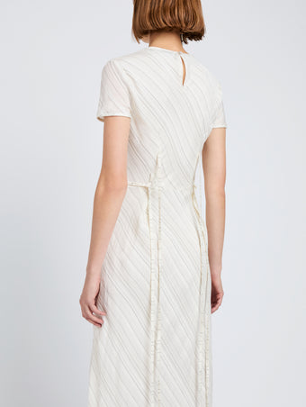 Proenza Schouler detail image of model wearing Delphine Dress in Woven Stripe Flou in chalk/black