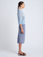 Proenza Schouler Side full length image of model wearing Nicola Knit Sweater in Plaited Viscose Rib in Light Oxford