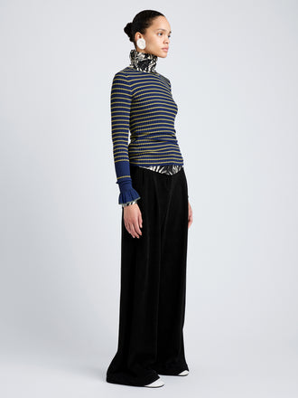 Proenza Schouler Side full length image of model wearing Yasmine Sweater in Multi Stripe Knit in NavyYellow