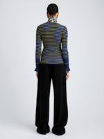 Proenza Schouler Back full length image of model wearing Yasmine Sweater in Multi Stripe Knit in NavyYellow