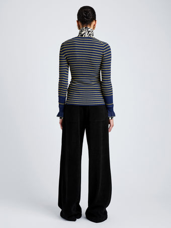 Proenza Schouler Back full length image of model wearing Yasmine Sweater in Multi Stripe Knit in NavyYellow