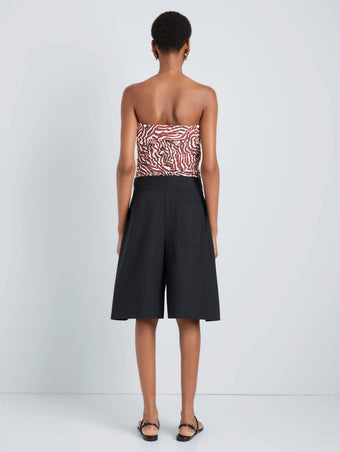 Proenza Schouler Back full length image of model wearing Maisy Strapless Top in Poplin in Rust Cream Multi