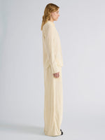 Proenza Schouler Side full length image of model wearing Meadow Pant in Crushed Velvet in Pale Yellow