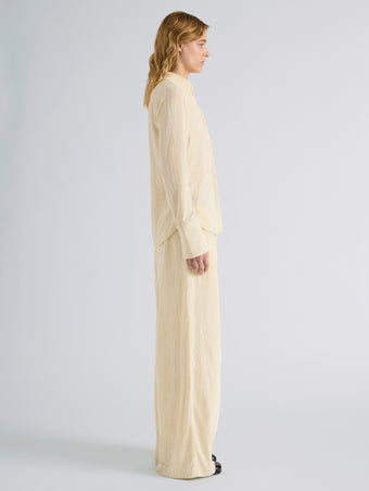 Proenza Schouler Side full length image of model wearing Meadow Pant in Crushed Velvet in Pale Yellow