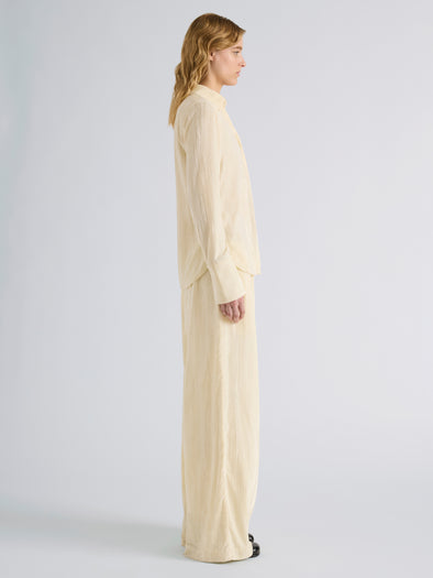 Proenza Schouler Side full length image of model wearing Meadow Pant in Crushed Velvet in Pale Yellow
