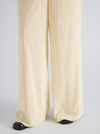 Proenza Schouler Detail image of model wearing Meadow Pant in Crushed Velvet in Pale Yellow