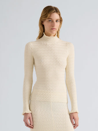 Proenza Schouler Detail image of model wearing Juniper Sweater in Cable Knit in Vanilla