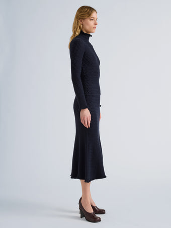 Proenza Schouler Side full length image of model wearing Juniper Sweater in Cable Knit in Navy