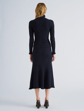 Proenza Schouler Back full length image of model wearing Juniper Sweater in Cable Knit in Navy