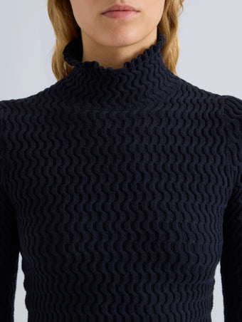 Proenza Schouler Detail image of model wearing Juniper Sweater in Cable Knit in Navy